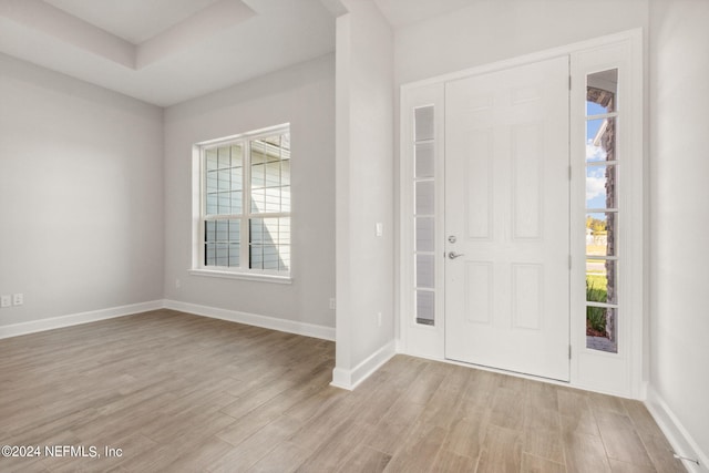 85425 Sandy Ridge Loop Unit 0085, Yulee, FL 32097 - foyer entrance featuring a tray ceiling, baseboards, and light wood finished floors