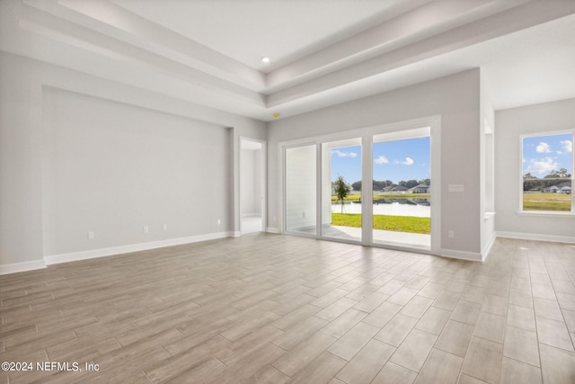 85425 Sandy Ridge Loop Unit 0085, Yulee, FL 32097 - unfurnished living room with light wood-style flooring, a water view, a wealth of natural light, and baseboards
