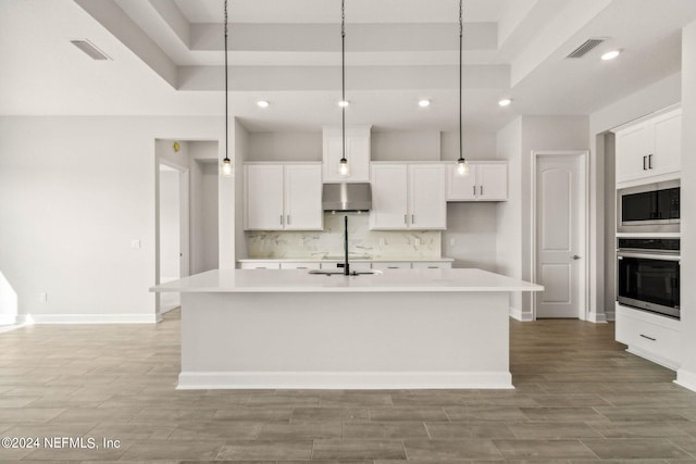 85425 Sandy Ridge Loop Unit 0085, Yulee, FL 32097 - kitchen featuring hanging light fixtures, appliances with stainless steel finishes, light countertops, and a kitchen island with sink