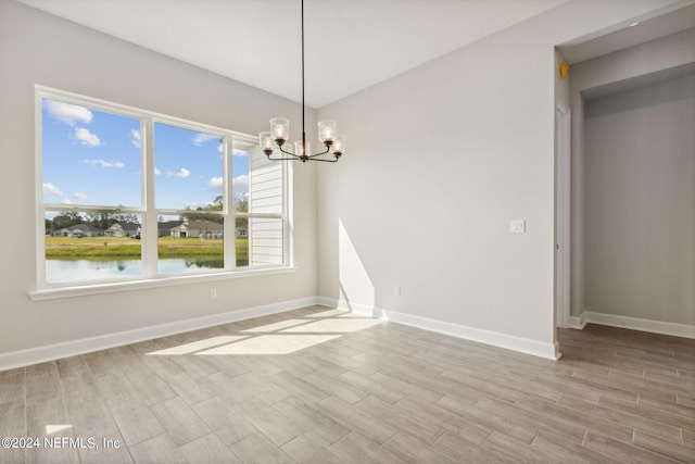 85425 Sandy Ridge Loop Unit 0085, Yulee, FL 32097 - unfurnished dining area with a water view, wood tiled floor, baseboards, and a notable chandelier