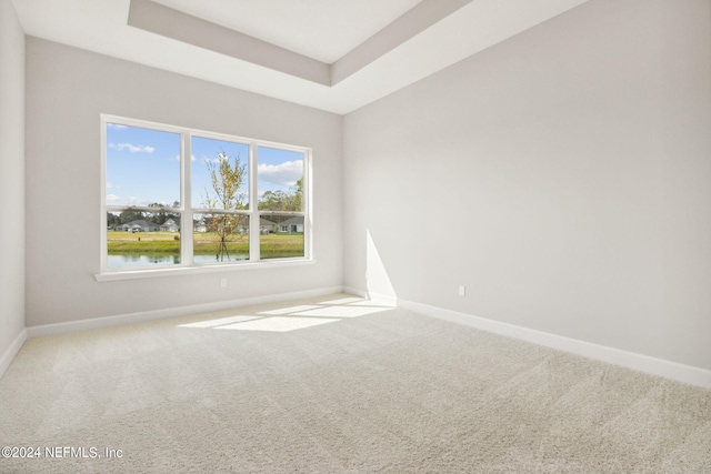 85425 Sandy Ridge Loop Unit 0085, Yulee, FL 32097 - carpeted spare room featuring a water view, a raised ceiling, and baseboards