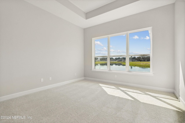 85425 Sandy Ridge Loop Unit 0085, Yulee, FL 32097 - unfurnished room featuring a water view, a raised ceiling, light colored carpet, and baseboards