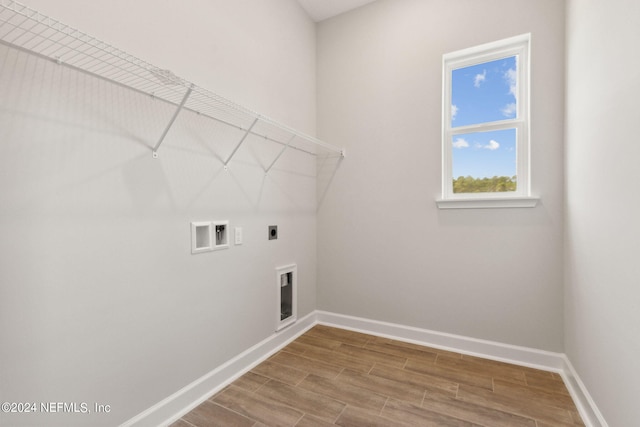 85425 Sandy Ridge Loop Unit 0085, Yulee, FL 32097 - clothes washing area featuring hookup for a washing machine, hookup for an electric dryer, laundry area, wood finished floors, and baseboards