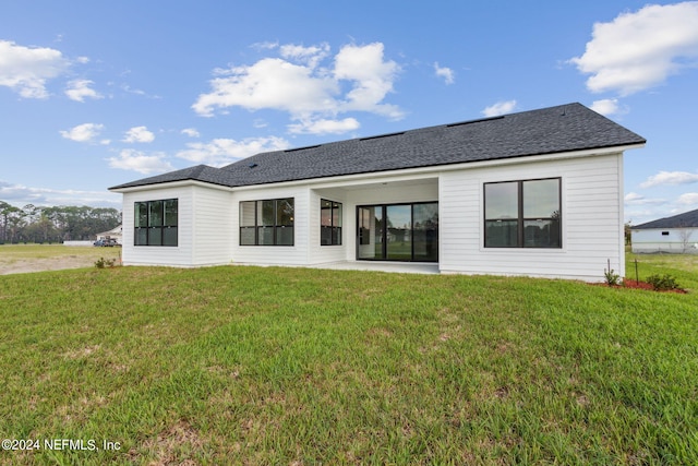 85425 Sandy Ridge Loop Unit 0085, Yulee, FL 32097 - back of property featuring a patio area, a yard, and roof with shingles