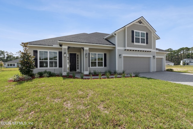 view of front of home featuring a front yard and a garage