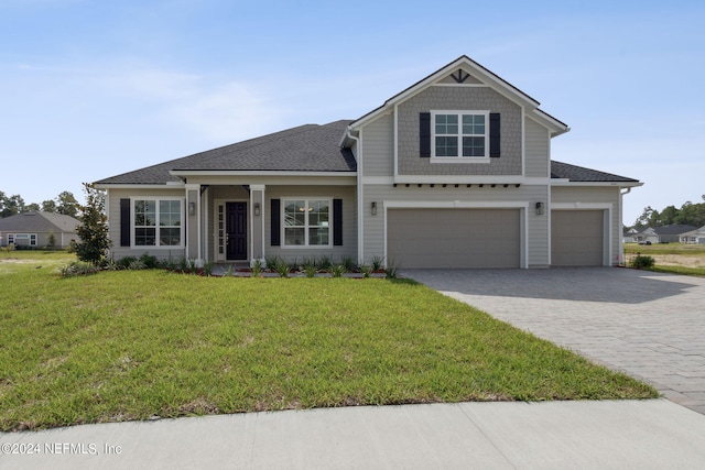 view of front of house featuring a front yard and a garage