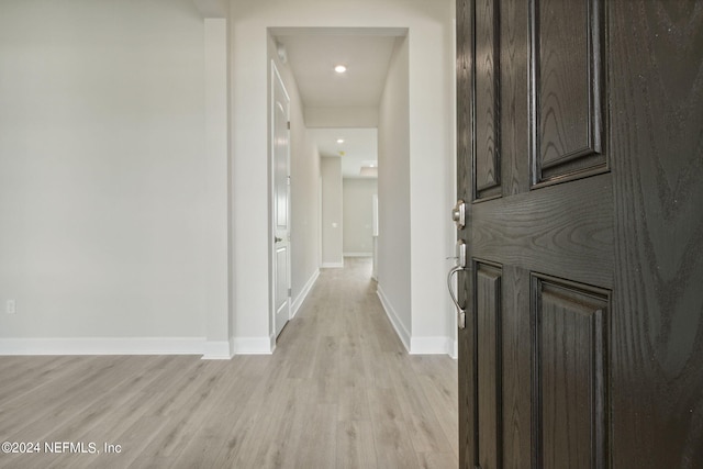 corridor with light wood-type flooring