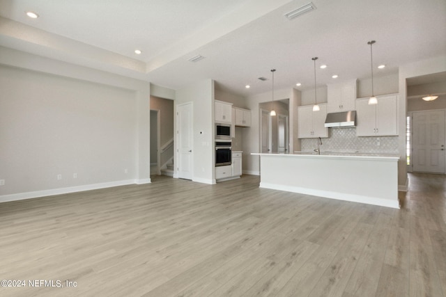 unfurnished living room featuring light hardwood / wood-style flooring and sink