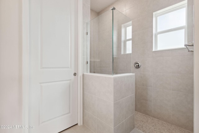 bathroom with tiled shower