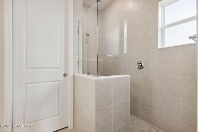 bathroom with a tile shower