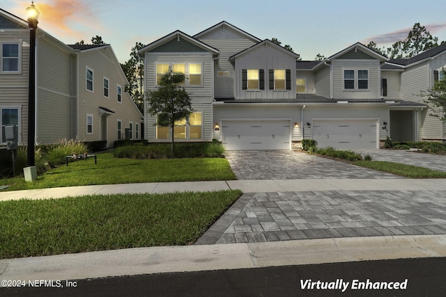 view of front of house featuring a garage and a yard