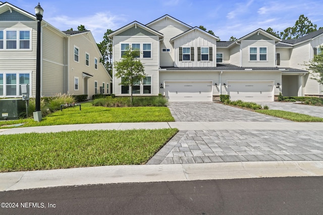 view of front of home with a garage and a front lawn