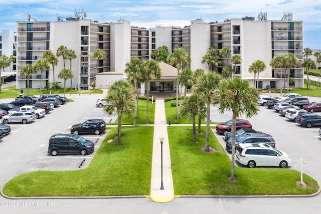 view of parking featuring a yard