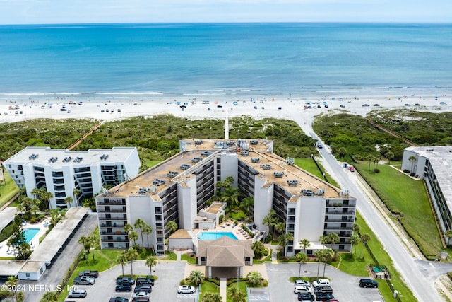 drone / aerial view with a water view and a beach view