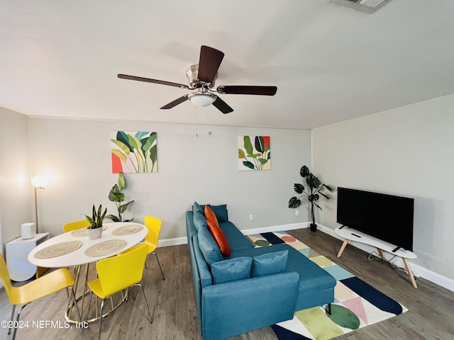 living room with ceiling fan and dark hardwood / wood-style floors