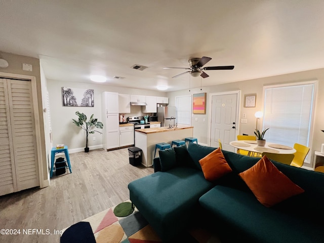 living room featuring ceiling fan and light wood-type flooring