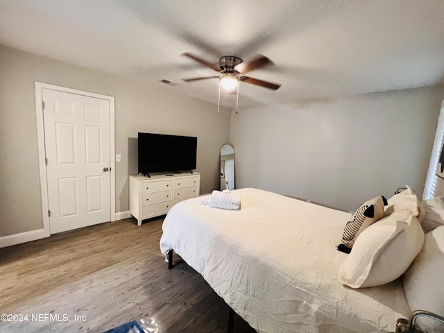 bedroom featuring wood-type flooring and ceiling fan