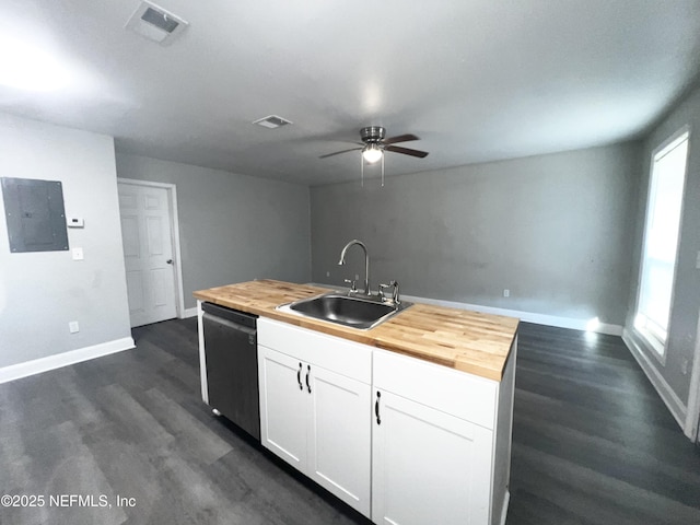 kitchen featuring sink, butcher block countertops, black dishwasher, a kitchen island with sink, and white cabinets