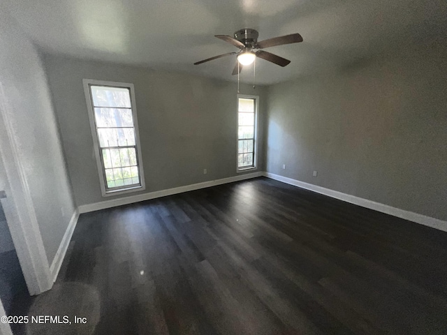 unfurnished room featuring ceiling fan and dark hardwood / wood-style flooring