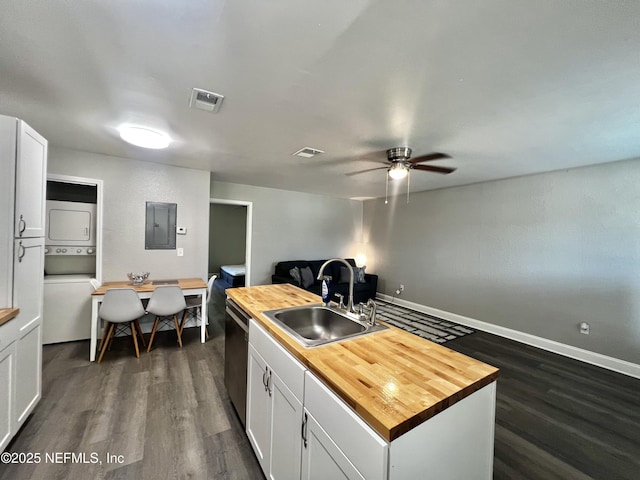 7815 Jasper Ave, Jacksonville, FL 32211 - kitchen with wood counters, electric panel, a sink, stacked washer and clothes dryer, and dark wood-type flooring