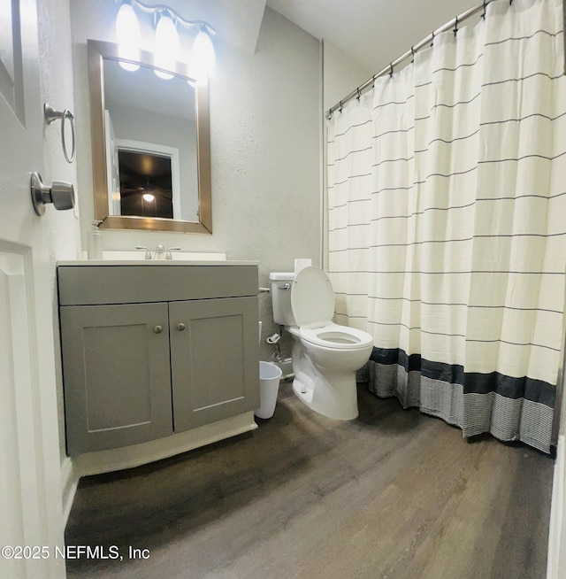 7815 Jasper Ave, Jacksonville, FL 32211 - bathroom with curtained shower, wood finished floors, toilet, and vanity