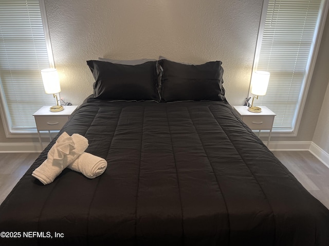 7815 Jasper Ave, Jacksonville, FL 32211 - bedroom with baseboards and wood finished floors