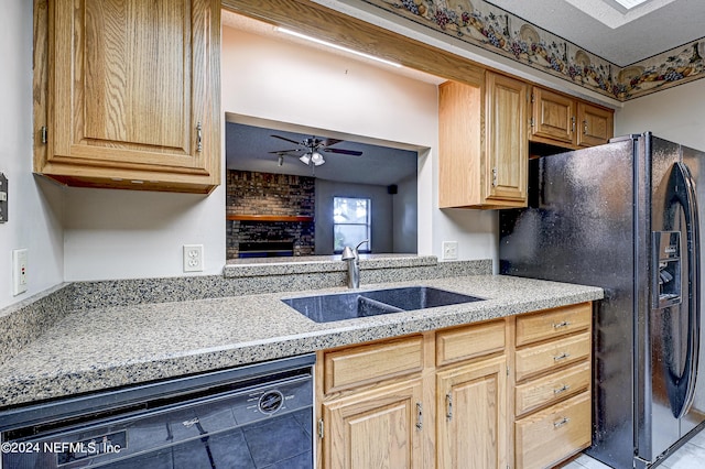 kitchen with ceiling fan, sink, a fireplace, light tile patterned floors, and black appliances