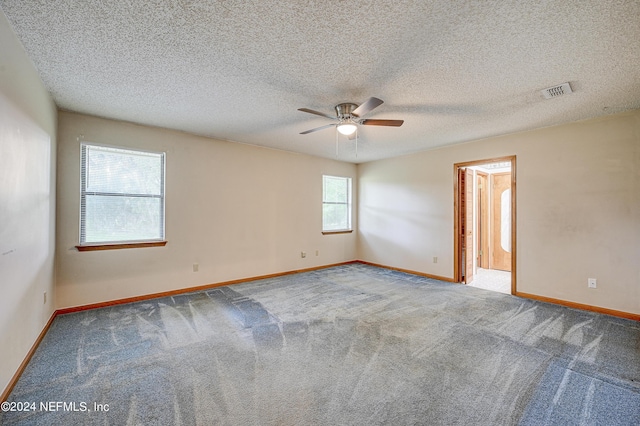 unfurnished room featuring carpet, a textured ceiling, and ceiling fan