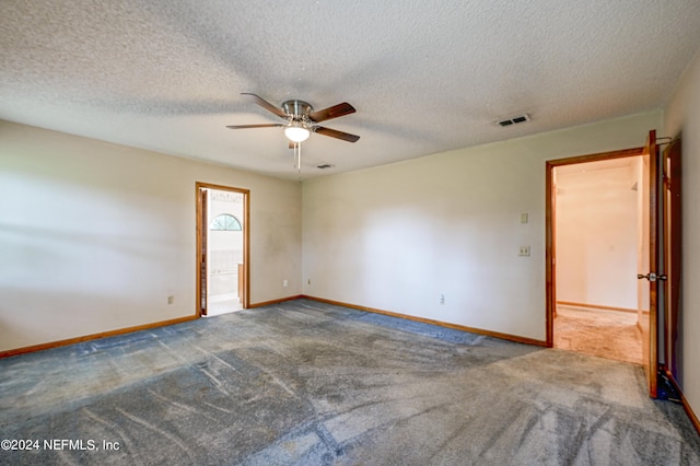 empty room with ceiling fan, carpet, and a textured ceiling