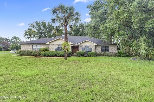 ranch-style home featuring a front yard