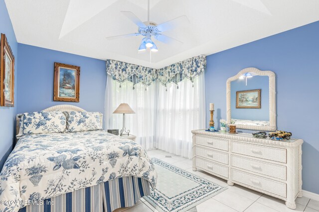 tiled bedroom with lofted ceiling and ceiling fan