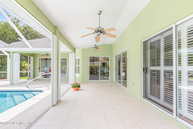 unfurnished sunroom featuring ceiling fan