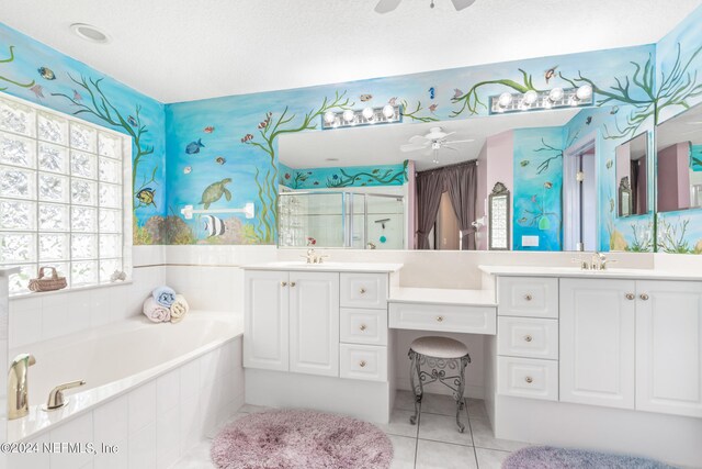 bathroom with vanity, tile patterned floors, ceiling fan, and a relaxing tiled tub