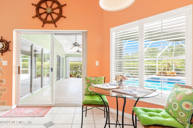 dining room featuring a healthy amount of sunlight, light tile patterned floors, and ceiling fan