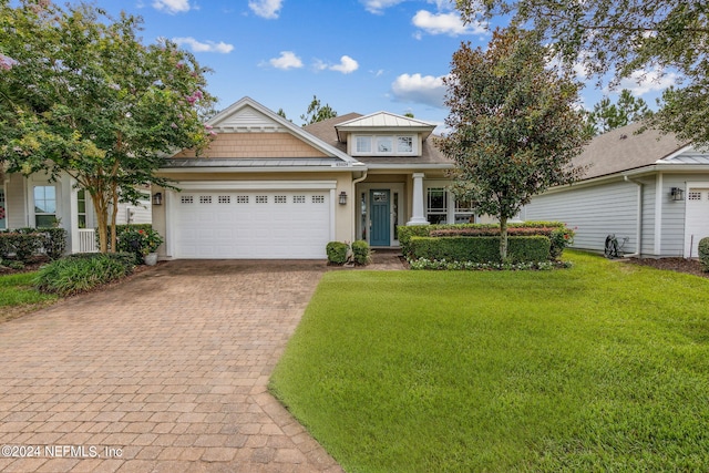 view of front of home featuring a garage and a front yard