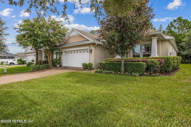 view of front of property featuring a front yard and a garage