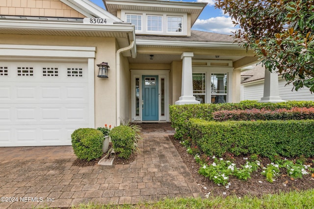 doorway to property with a garage