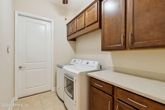 washroom featuring washer and dryer, ceiling fan, cabinets, and light tile patterned flooring