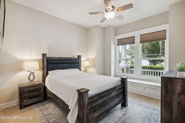 tiled bedroom featuring ceiling fan