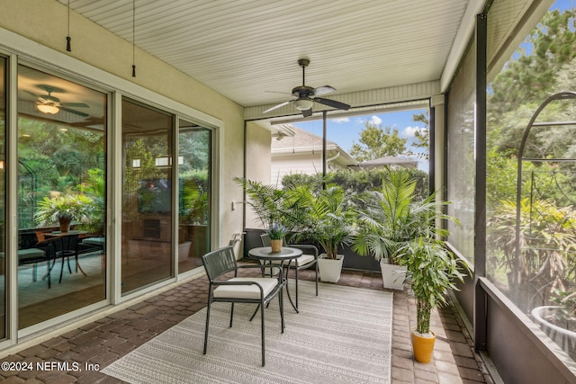 sunroom / solarium featuring ceiling fan