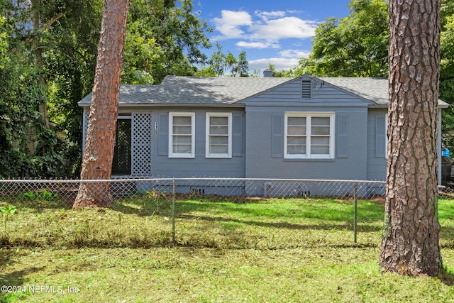 view of side of property with a lawn