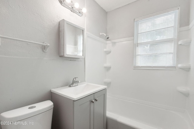 full bathroom with vanity, a wealth of natural light, toilet, and washtub / shower combination