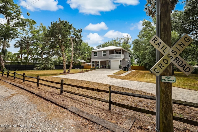 view of front of house featuring a garage and a front lawn