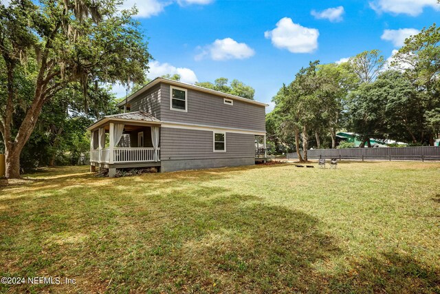 rear view of house with a lawn