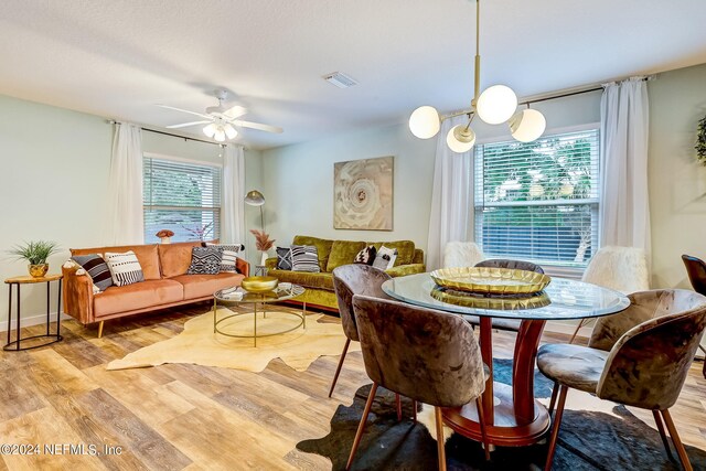 dining area with light hardwood / wood-style floors and ceiling fan