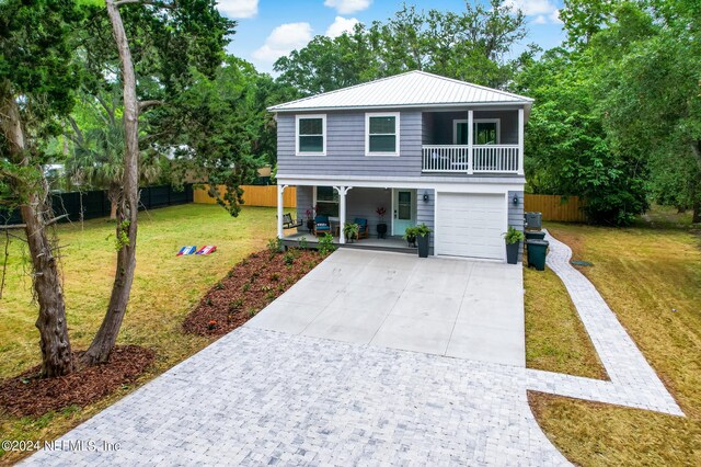 view of front of house featuring a garage and a front lawn