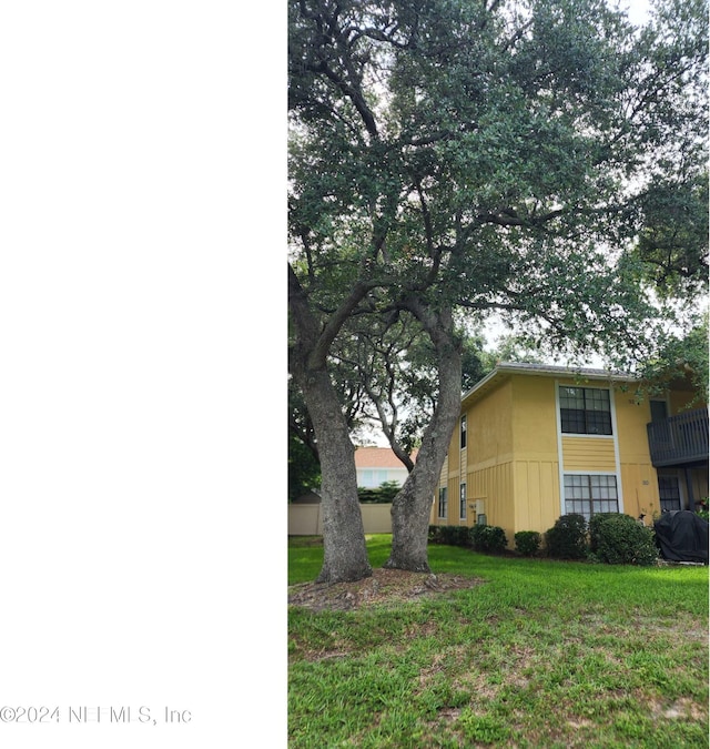 view of side of property with a lawn