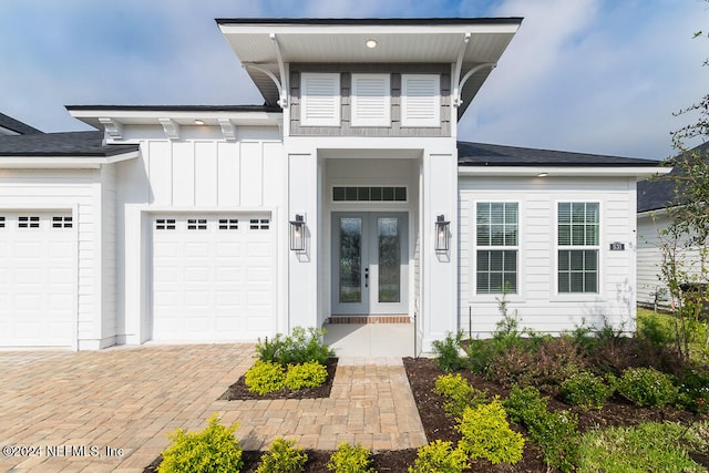 property entrance featuring french doors and a garage