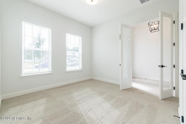 unfurnished bedroom featuring light carpet