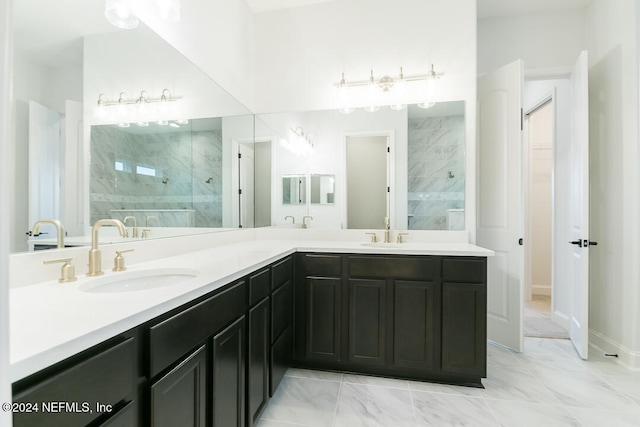 bathroom featuring a tile shower and vanity